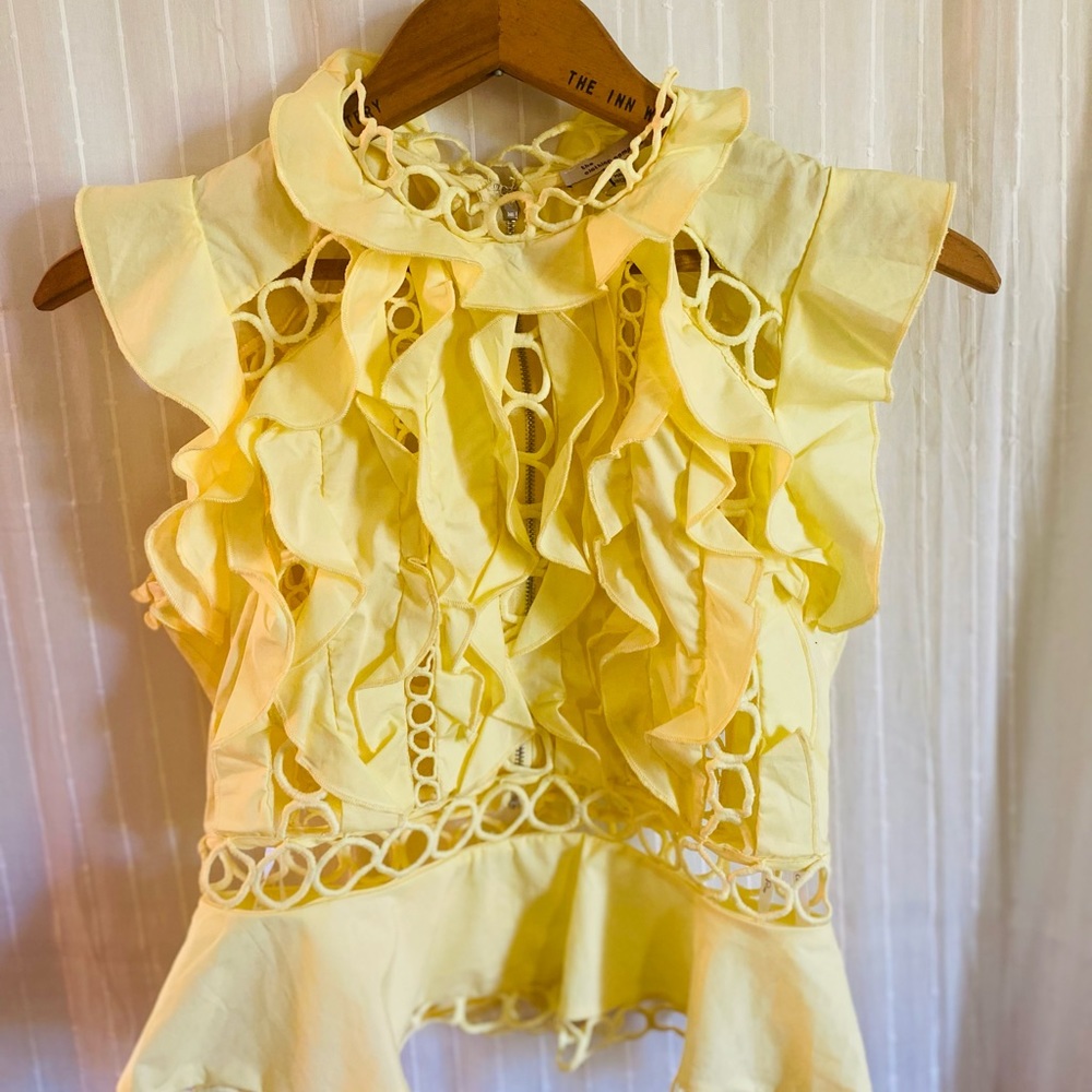 Summery yellow ruffled blouse.